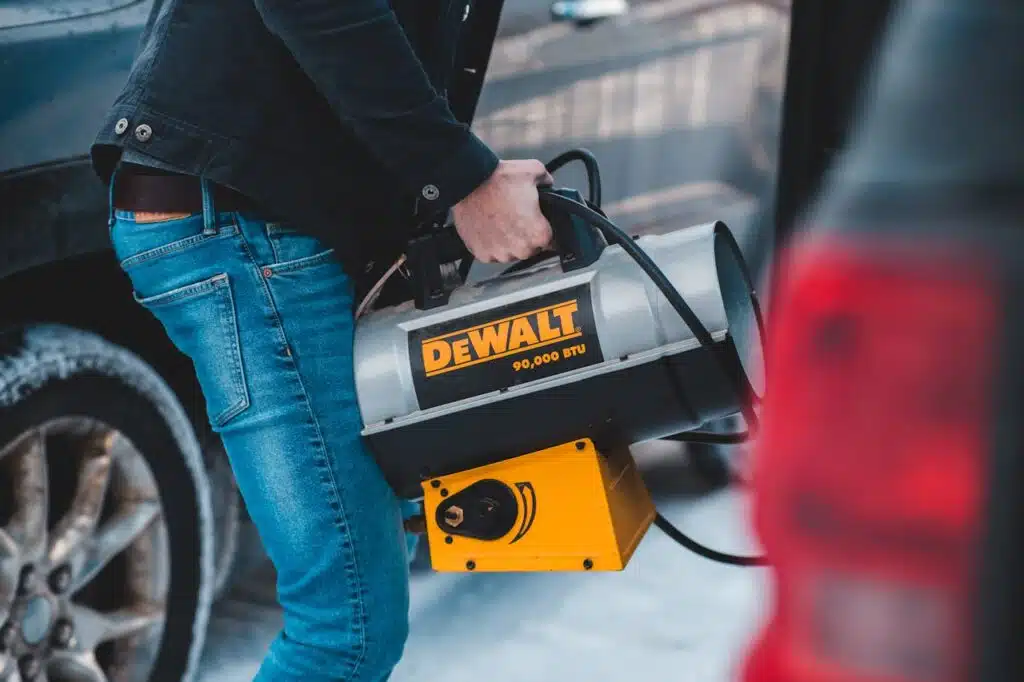 man carrying camping heater