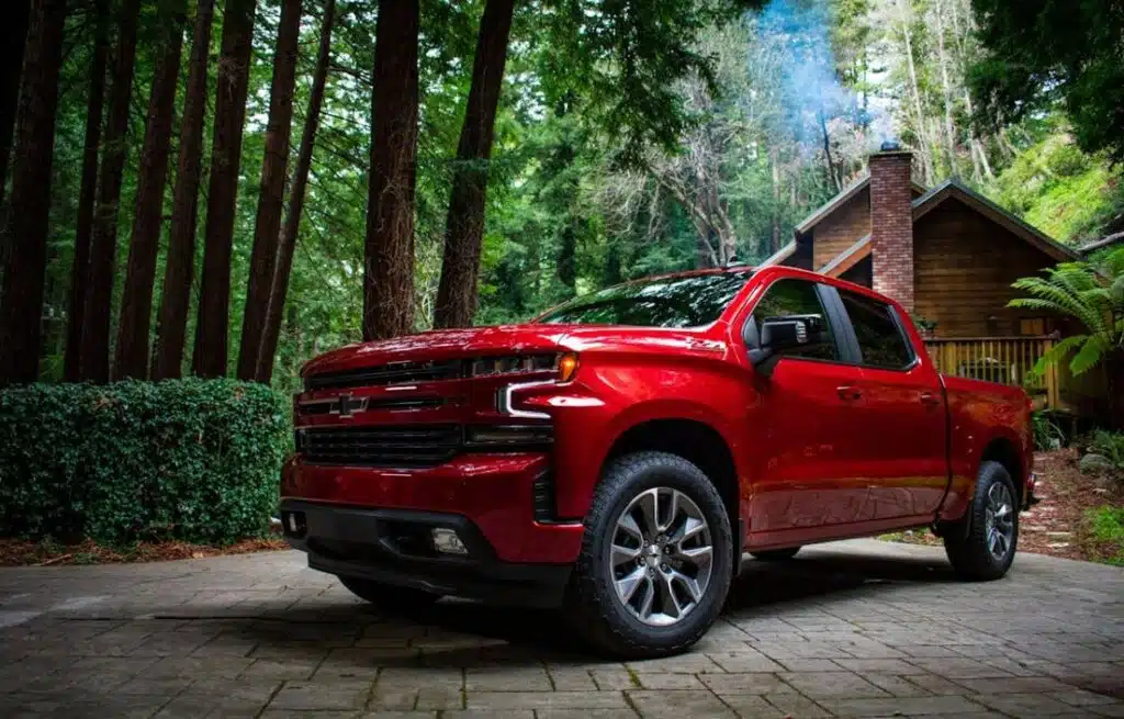 Red Chevrolet Silverado 1500 on the woods