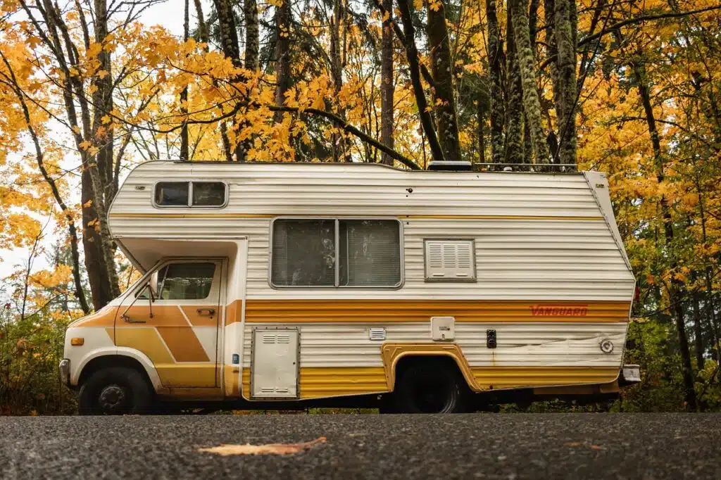 Yellow Camper van inthe woods