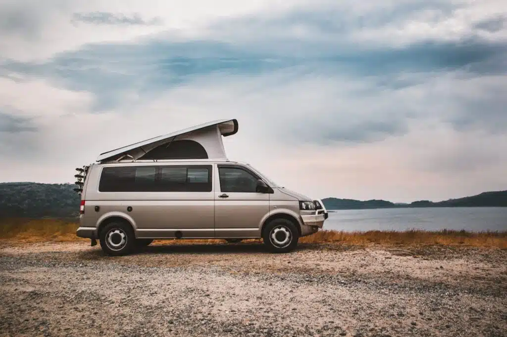 Silver campervan on a lakeside