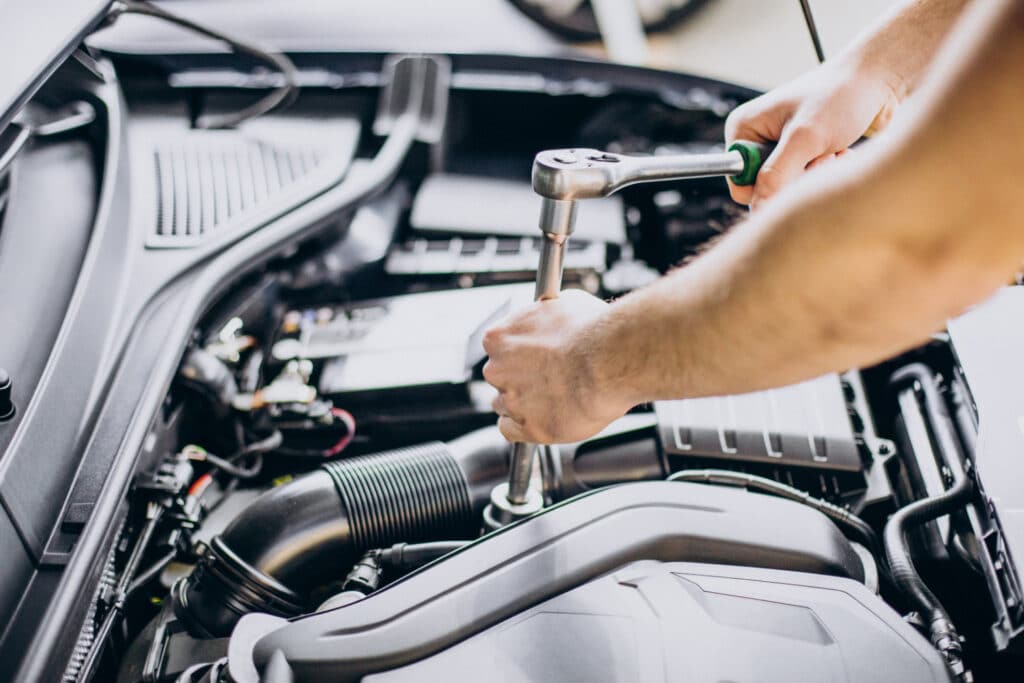 man fixing a car