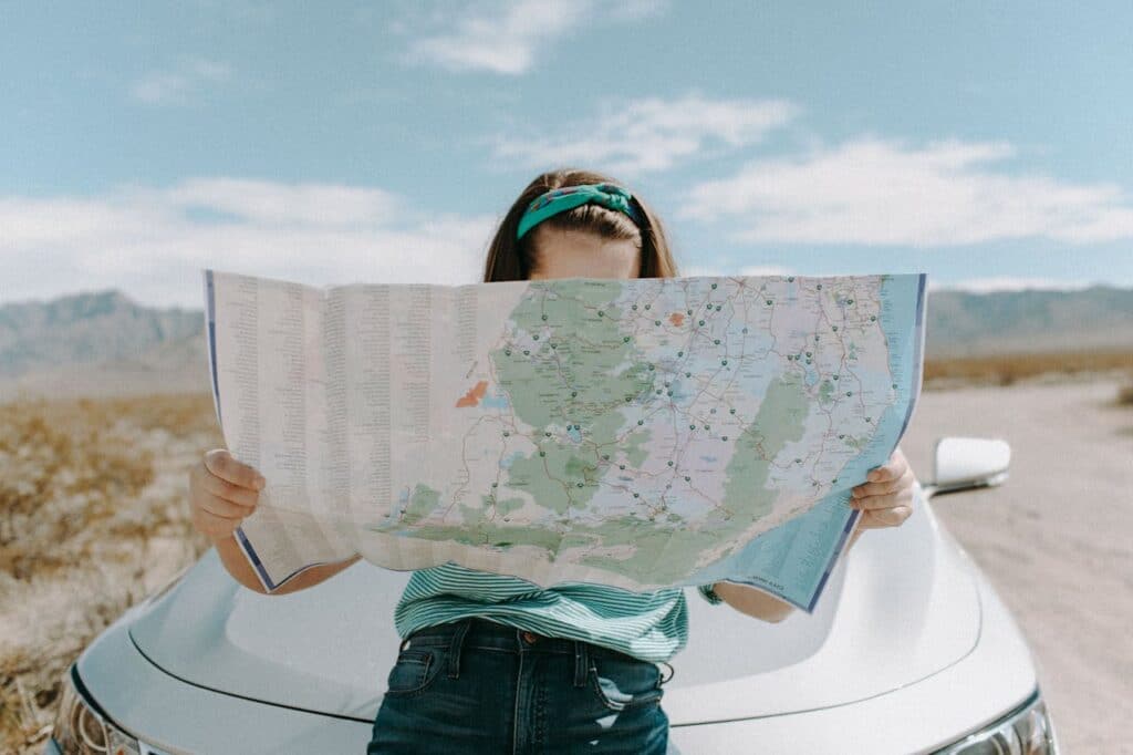 a woman looking at a big map